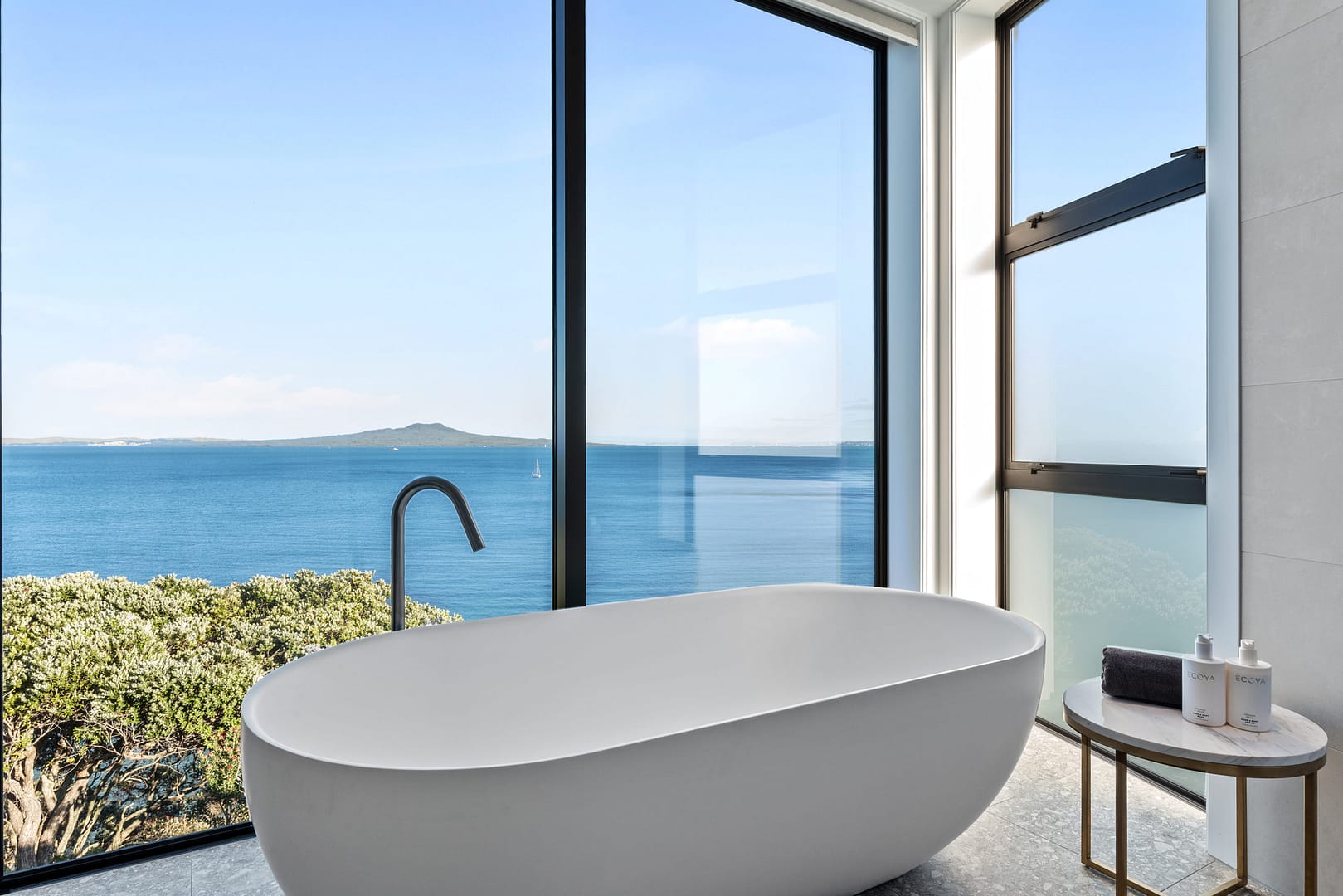 Starke 40mm architectural aluminium joinery, showing bath and view of rangitoto